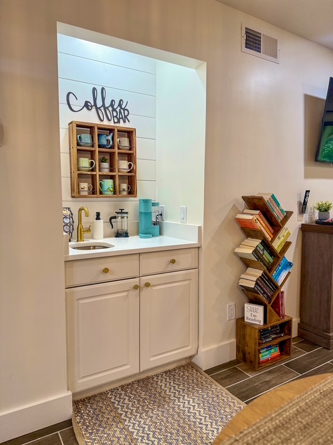 Built-in coffee bar with shiplap, mug shelf, and a bookshelf nook for guests