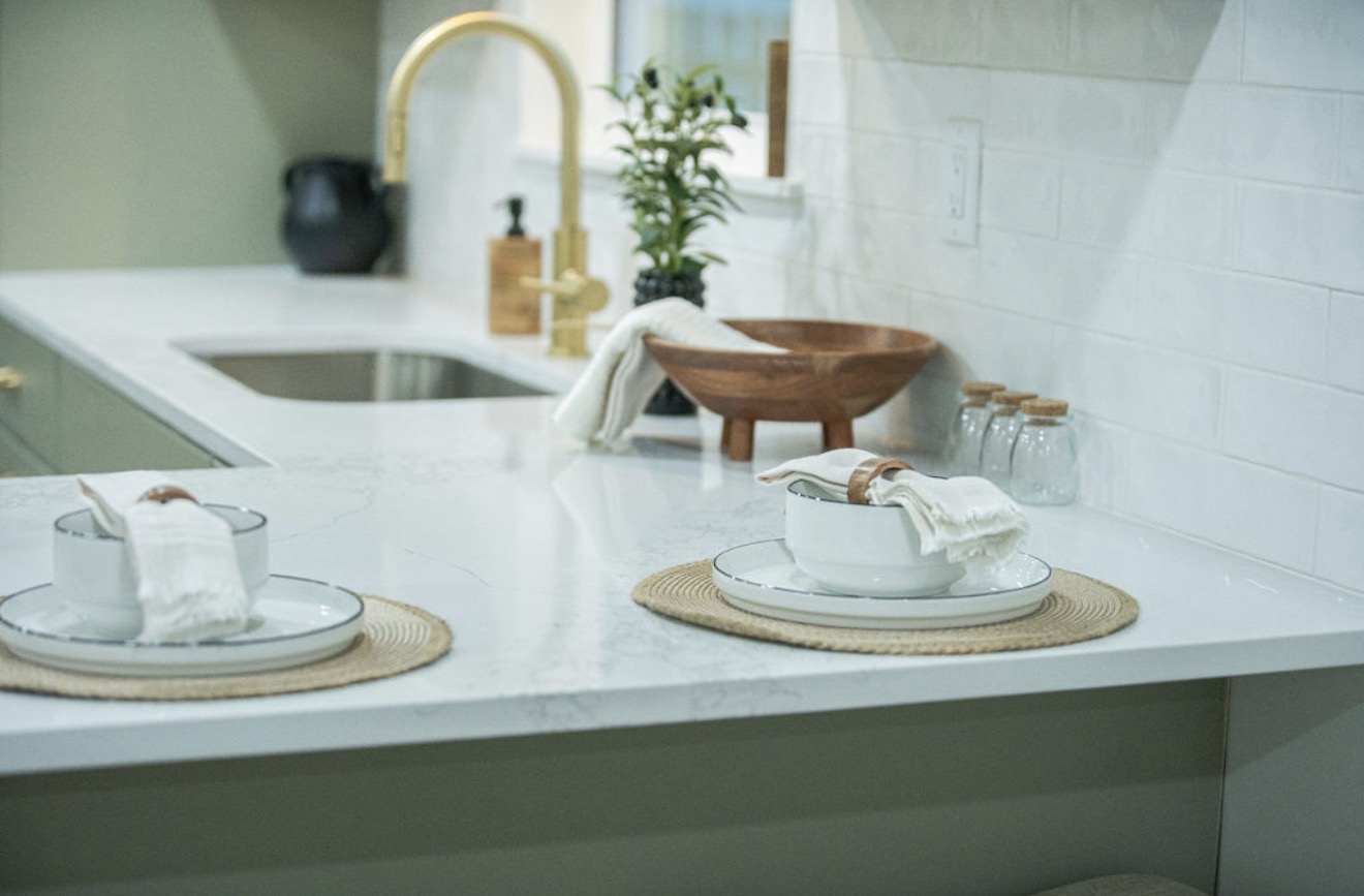 Kitchen counter detail with styled place settings and brass fixtures