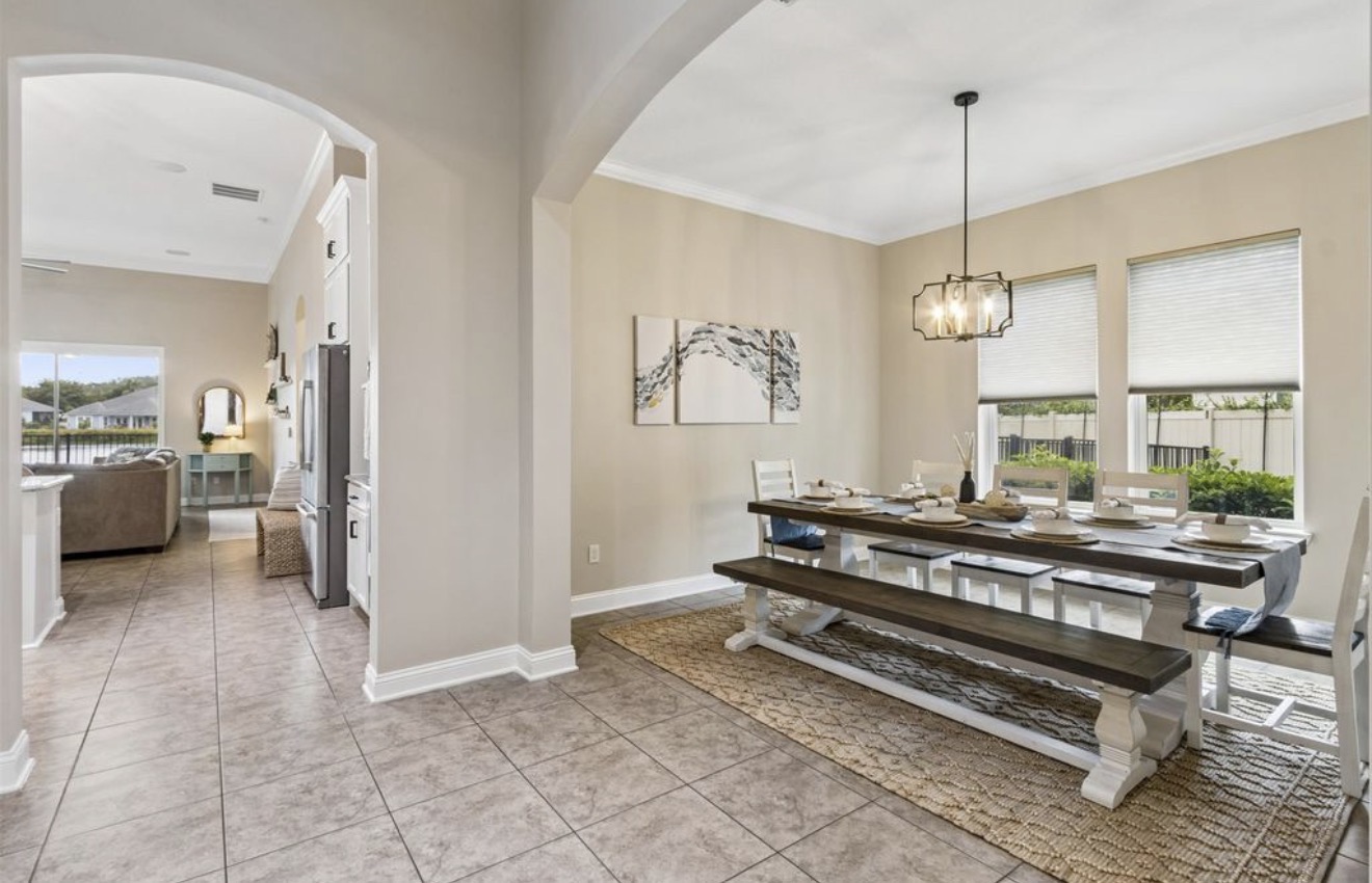 Dining room staged with a farmhouse table, bench seating, and jute rug